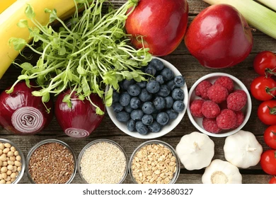 Fresh fruits, vegetables, seeds, and grains—some of the top 10 natural sources of prebiotics—are artfully arranged on a wooden surface, showcasing how to add prebiotics to your diet for better gut health.